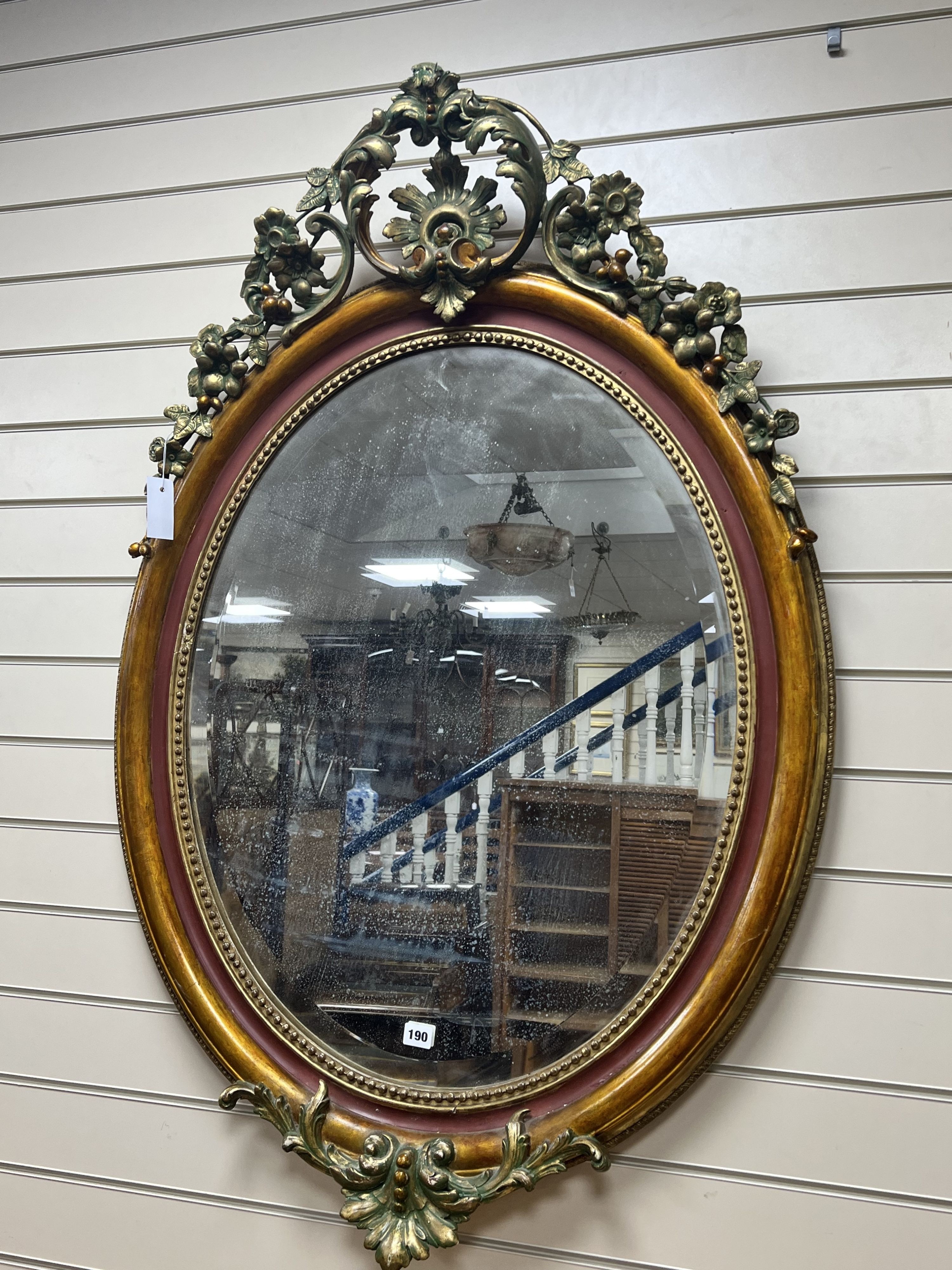 A late 19th century French oval giltwood and gesso wall mirror, later painted, width 81cm height 122cm